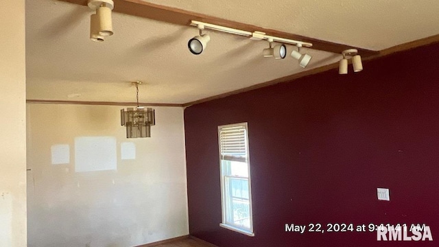 unfurnished room featuring crown molding