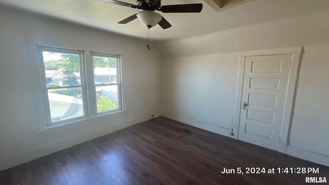 empty room featuring dark wood finished floors and lofted ceiling