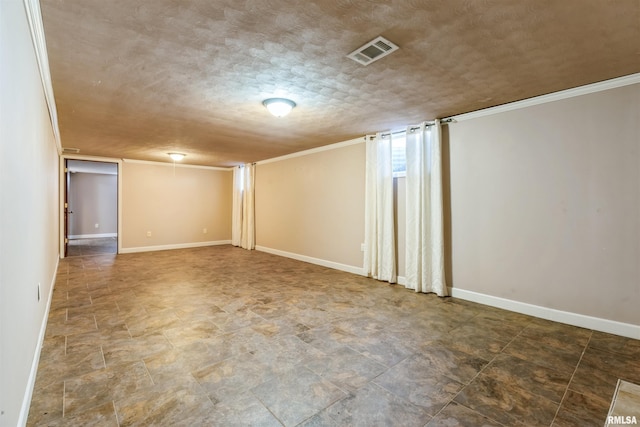 finished basement with visible vents, baseboards, and a textured ceiling