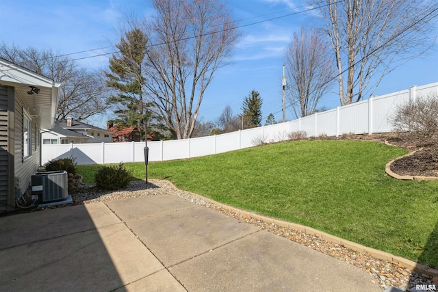 view of yard featuring a patio area, central AC unit, and a fenced backyard