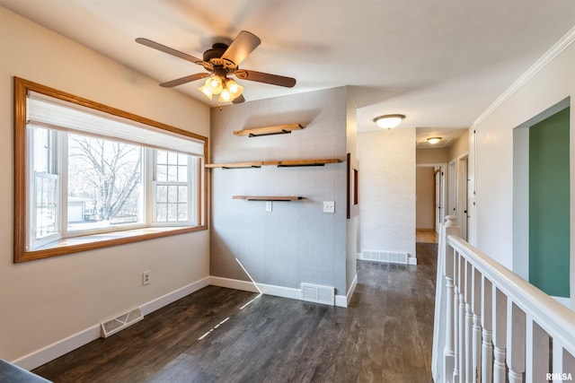 interior space featuring dark wood finished floors, baseboards, and visible vents