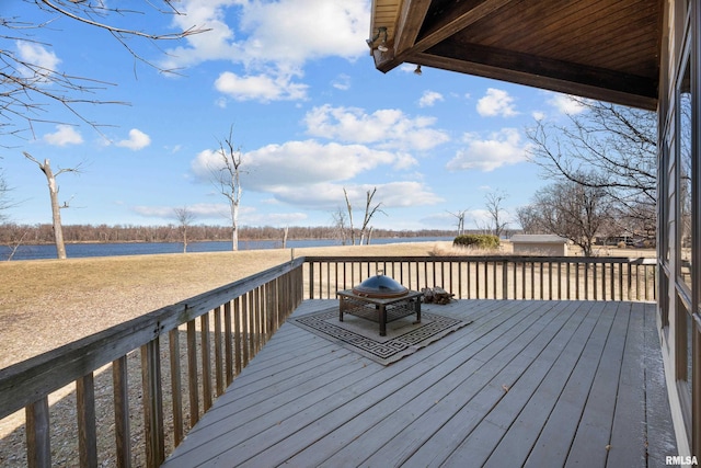 wooden deck featuring a water view