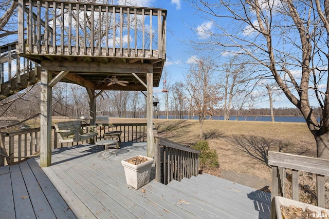 deck featuring a ceiling fan and a water view