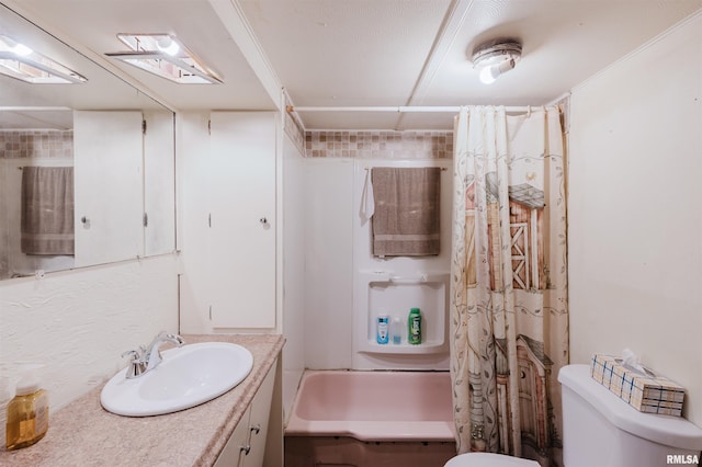 bathroom featuring vanity, shower / tub combo, and toilet