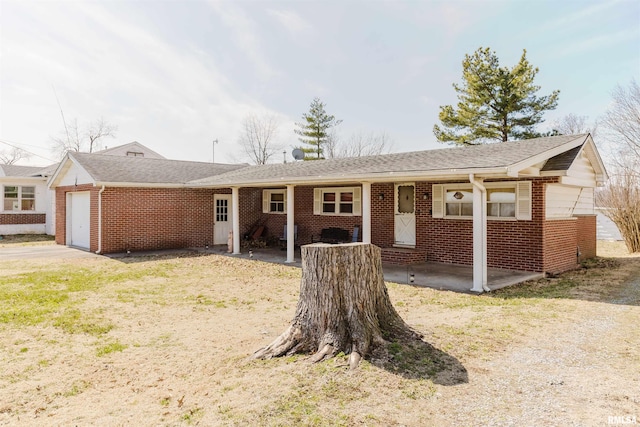 view of front of property featuring brick siding and a garage