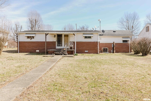 rear view of property featuring central AC unit, brick siding, and crawl space