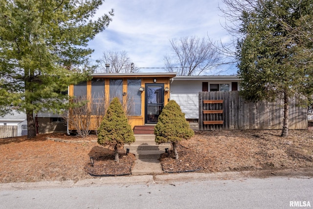 view of front of house with entry steps and fence