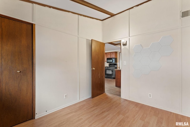 unfurnished bedroom featuring light wood-type flooring and visible vents