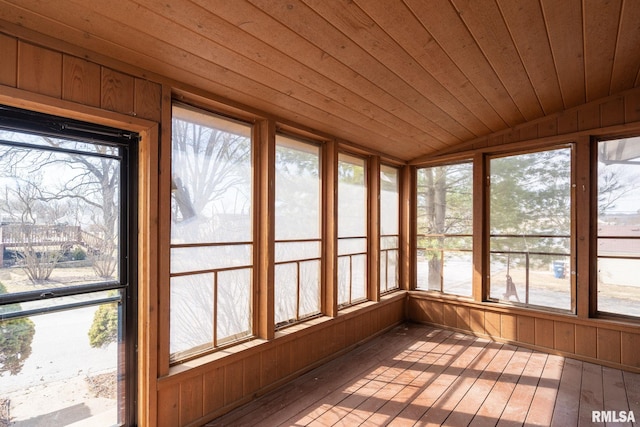 unfurnished sunroom with lofted ceiling and wooden ceiling