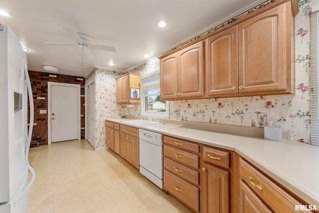 kitchen featuring wallpapered walls, light countertops, white appliances, a ceiling fan, and a sink