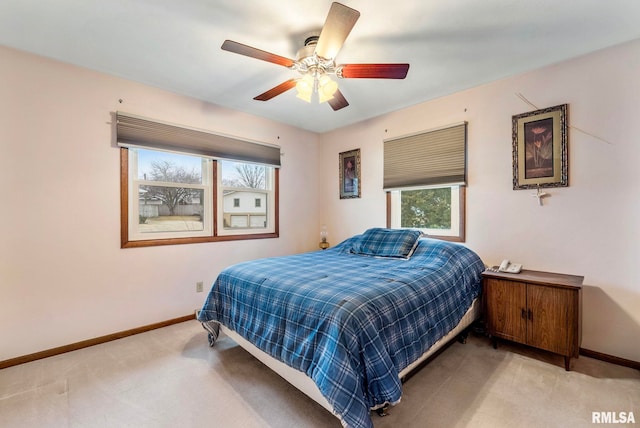 bedroom with ceiling fan, baseboards, and carpet