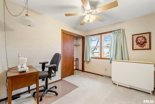 office with light carpet, visible vents, baseboards, and ceiling fan