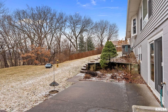 view of yard featuring central air condition unit and fence