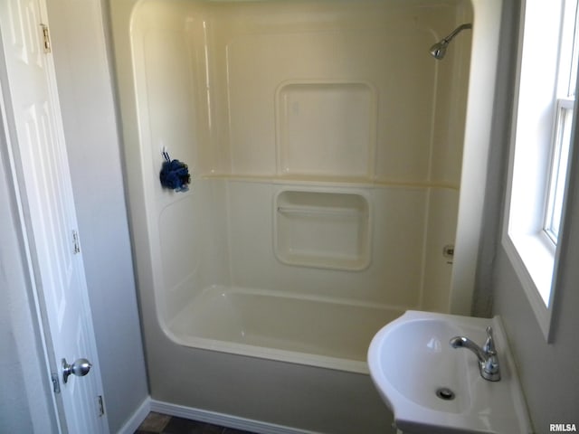 bathroom with shower / tub combination and a sink