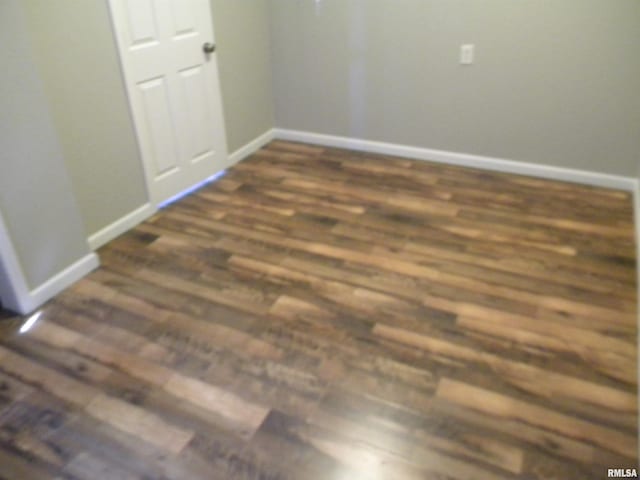 interior space with baseboards and dark wood-style floors