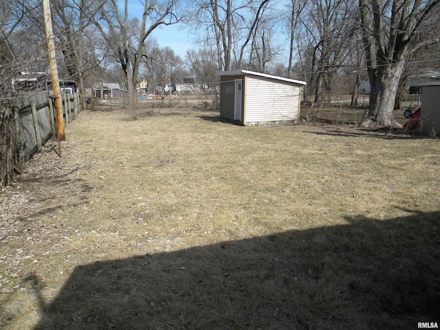 view of yard with a fenced backyard, an outdoor structure, and a shed