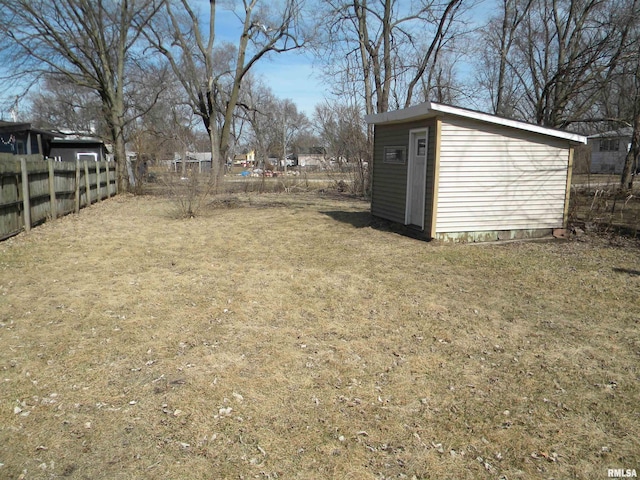 view of yard with a shed, an outdoor structure, and fence