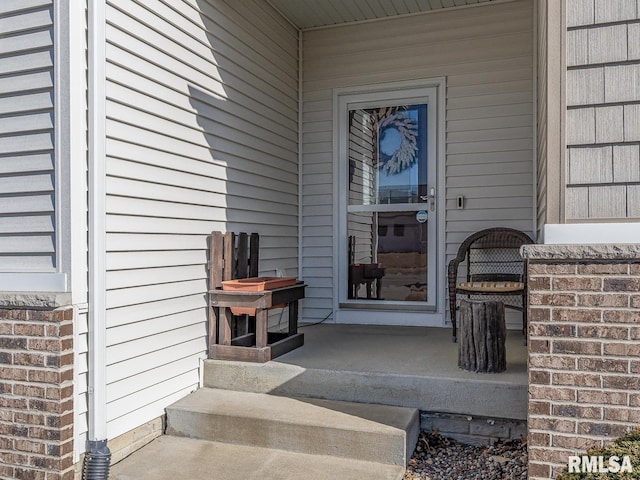 property entrance with brick siding