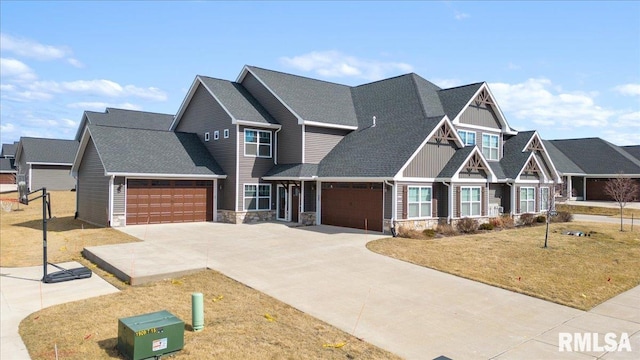 craftsman house with stone siding, a garage, driveway, and roof with shingles