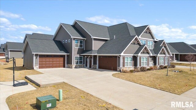 craftsman inspired home with stone siding, an attached garage, concrete driveway, a front yard, and roof with shingles