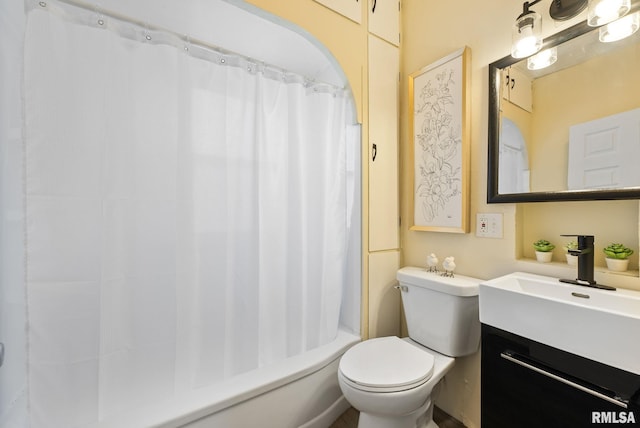 bathroom with shower / bath combo with shower curtain, toilet, and vanity