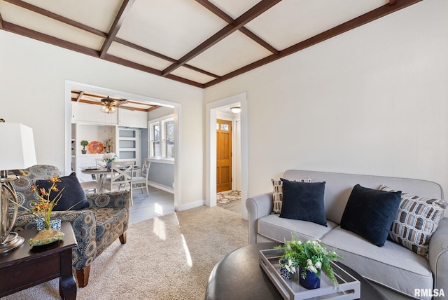 living area featuring beamed ceiling, carpet flooring, baseboards, and coffered ceiling