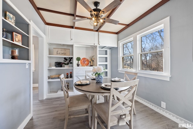 dining space featuring ceiling fan, baseboards, and wood finished floors