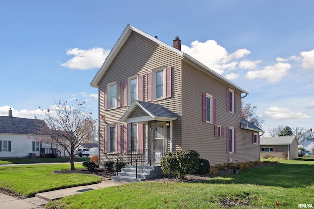 view of front of house with a front yard and a chimney