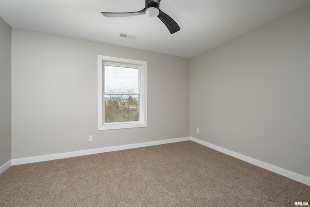 empty room featuring visible vents, carpet flooring, baseboards, and ceiling fan