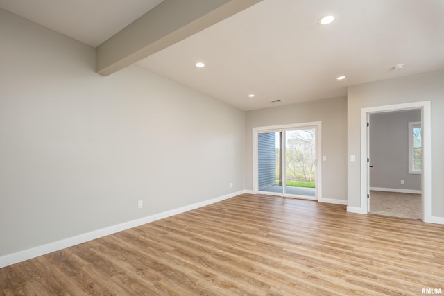 spare room featuring plenty of natural light, light wood-style floors, recessed lighting, and baseboards