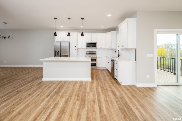 kitchen with tasteful backsplash, a center island, stainless steel appliances, and a sink