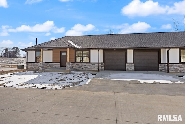 view of front of home with concrete driveway, a garage, stone siding, and a shingled roof