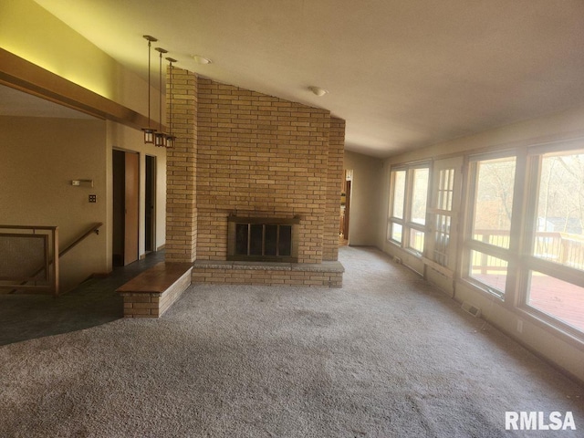 unfurnished living room with visible vents, a fireplace, carpet, and vaulted ceiling