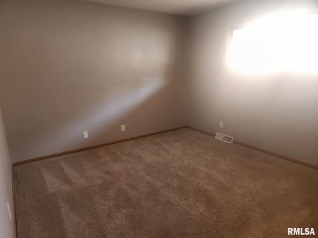 carpeted spare room with visible vents