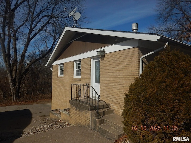 view of side of property with brick siding