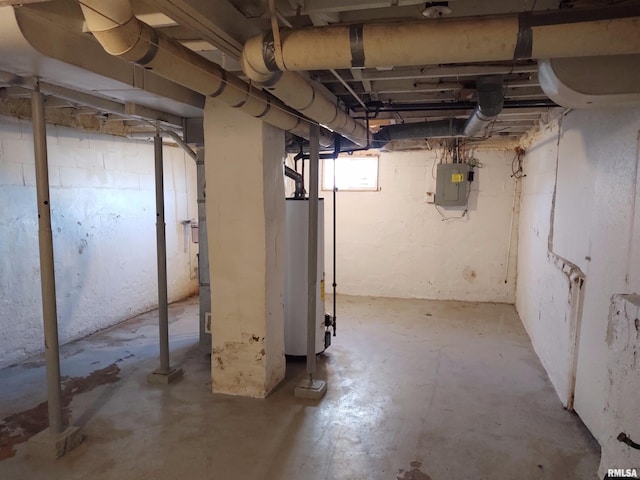 below grade area featuring electric panel and gas water heater