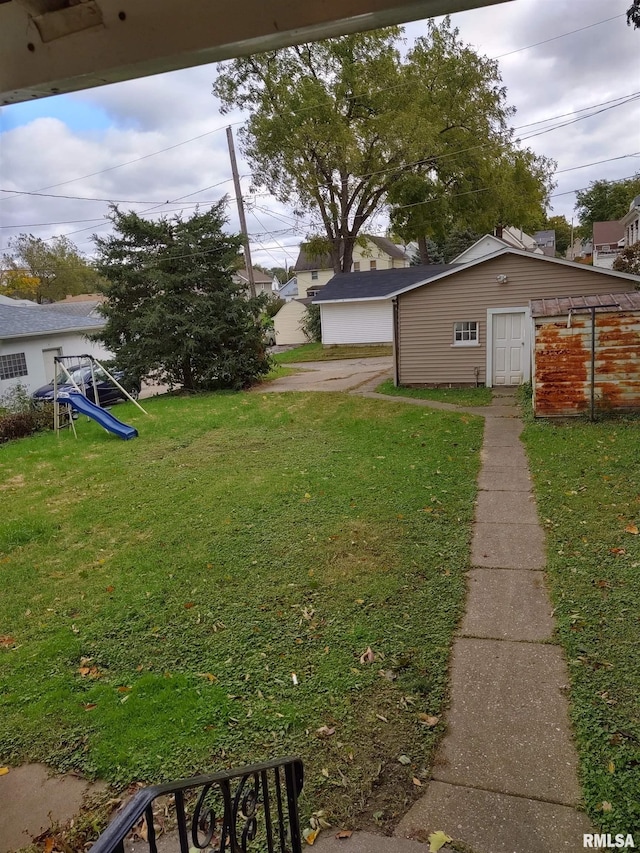 view of yard with an outbuilding and a playground