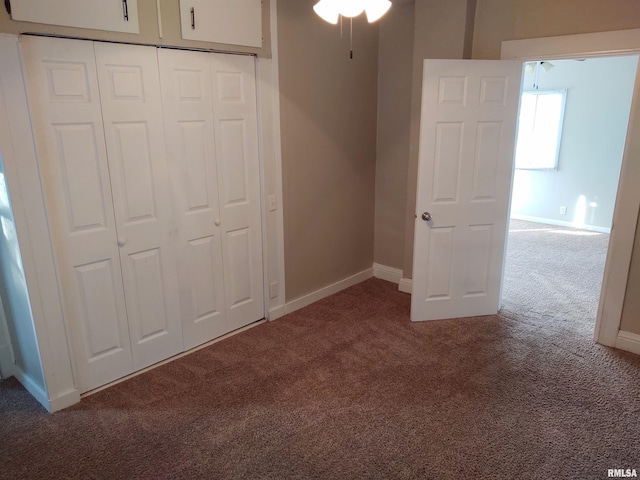 unfurnished bedroom featuring a closet, baseboards, and carpet