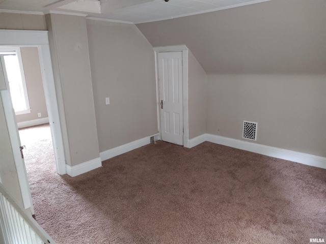 bonus room with visible vents, baseboards, lofted ceiling, and carpet