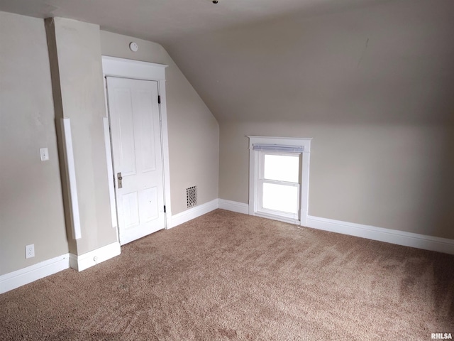 bonus room with vaulted ceiling, carpet flooring, and baseboards