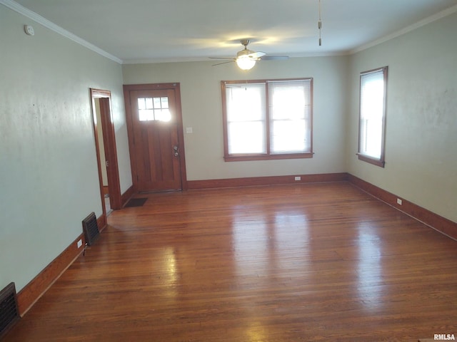 interior space featuring visible vents, crown molding, baseboards, and dark wood-style flooring