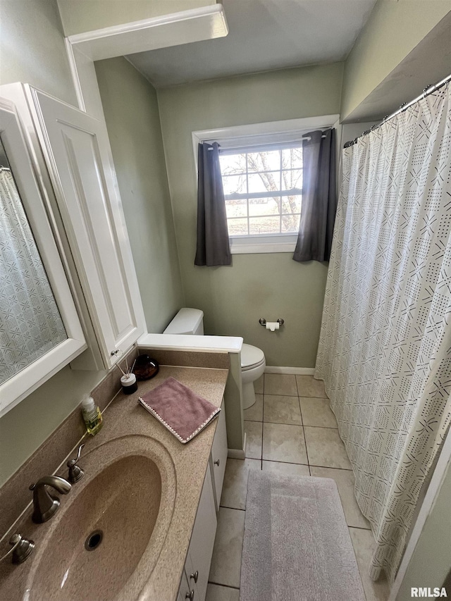 bathroom with vanity, tile patterned floors, toilet, and baseboards