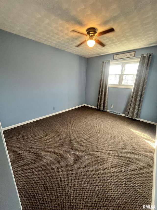 spare room with baseboards, visible vents, and a textured ceiling