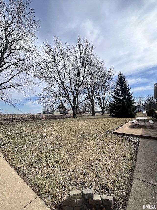 view of yard with a deck and fence