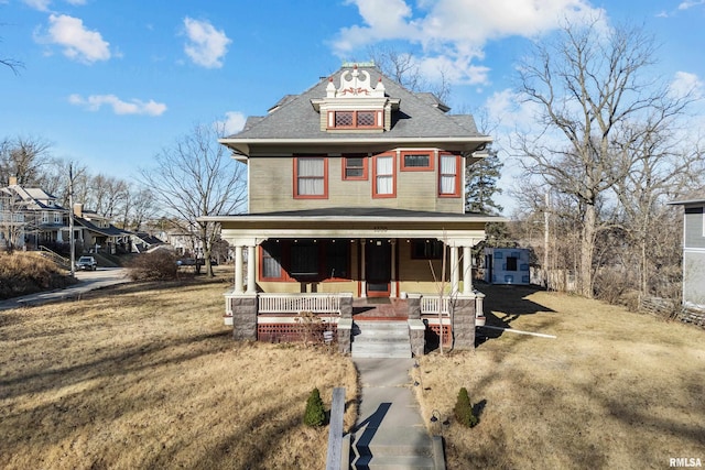 view of front of property with a porch and a front lawn