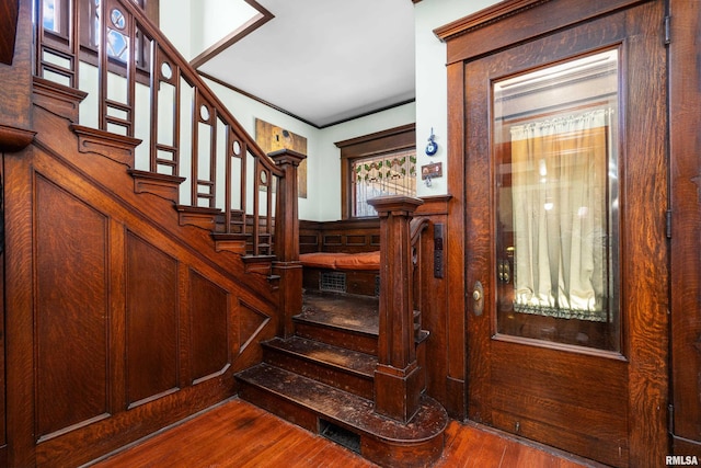 stairs featuring wood finished floors