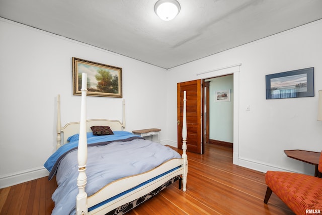 bedroom featuring baseboards and wood finished floors