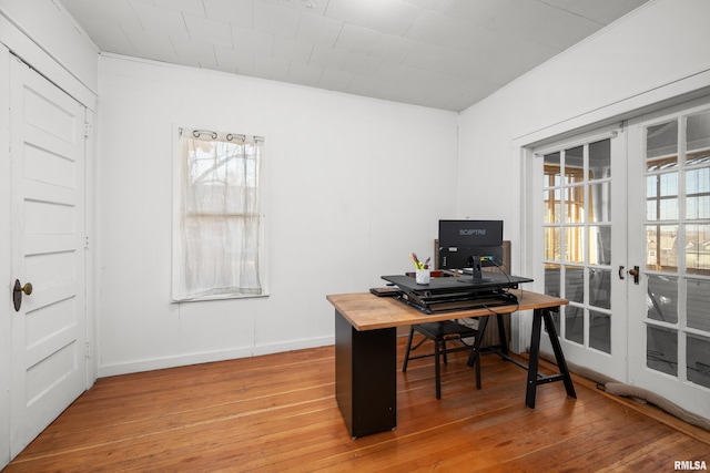 home office with french doors, baseboards, and light wood finished floors