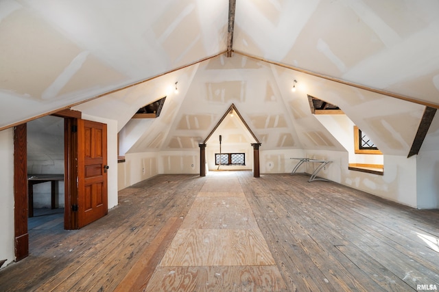 additional living space featuring lofted ceiling and hardwood / wood-style floors