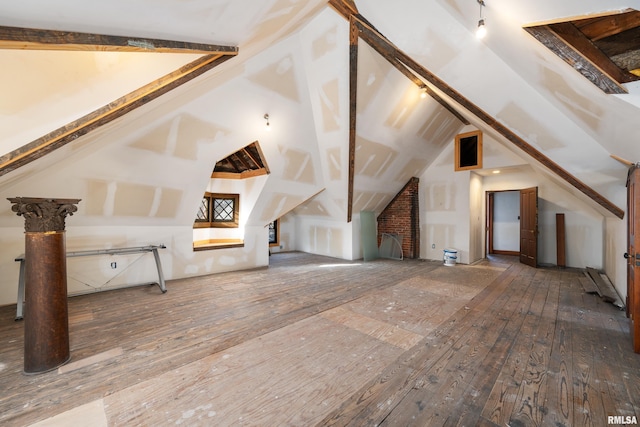 bonus room featuring hardwood / wood-style floors and vaulted ceiling